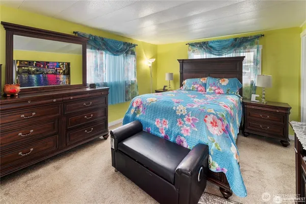a bedroom with a bed and a dresser
