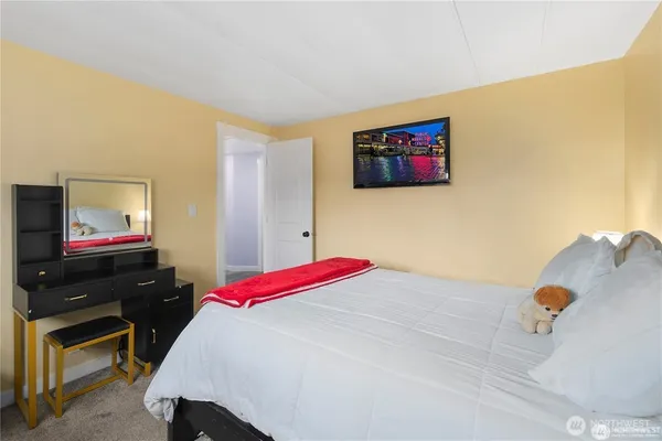 a bedroom with a bed and a flat screen tv