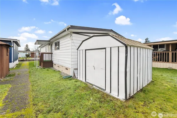 a view of a backyard with wooden fence