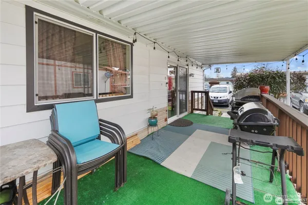 a view of a porch with furniture and a backyard