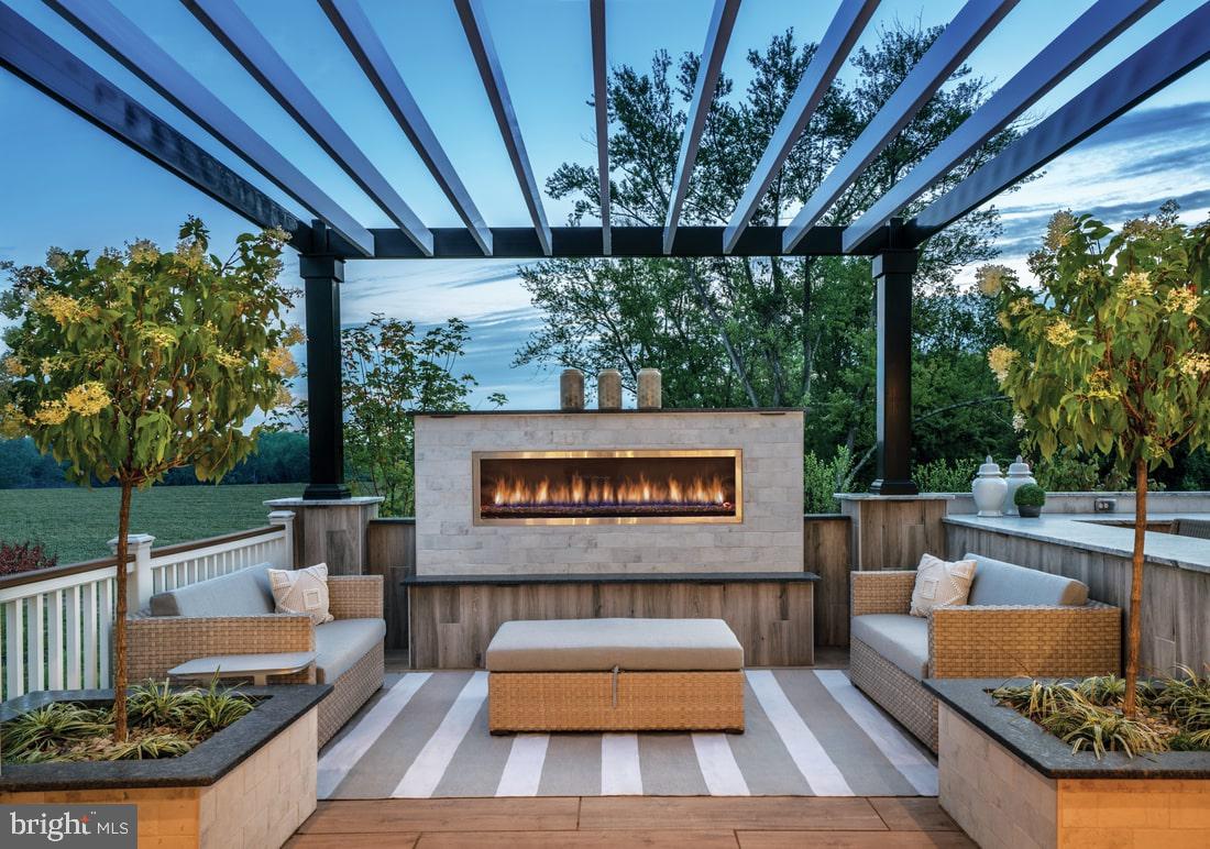 210 Gerry Way, Unit 251 Ambler, PA 19002 - Photo 10 of 11 a view of a patio with couches table and chairs with wooden floor and fence