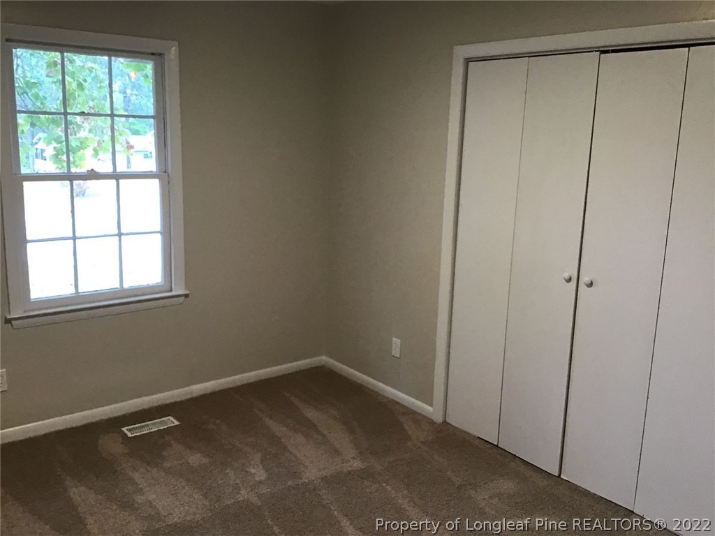 5035 Steed Road Fayetteville, NC 28306 - Photo 5 of 8 a view of an empty room with a window
