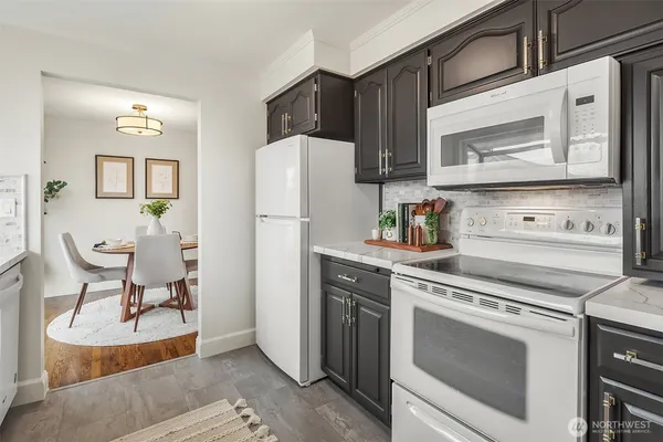 a kitchen with stainless steel appliances a stove a refrigerator and cabinets