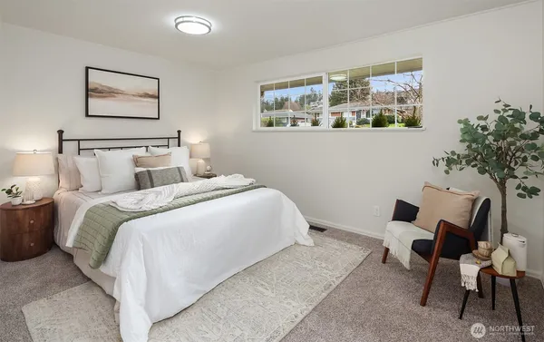 a bed room with a bed and a chair