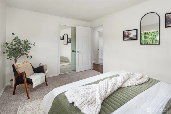 a bedroom with a bed and a chair