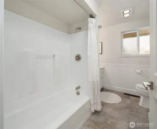 a bathroom with a bathtub and toilet