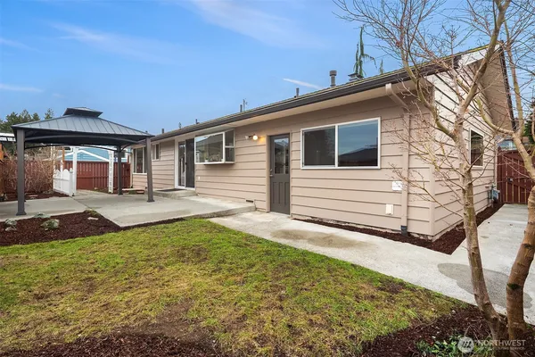 a backyard of a house with yard and outdoor seating