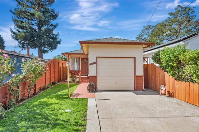 a view of a backyard with wooden fence