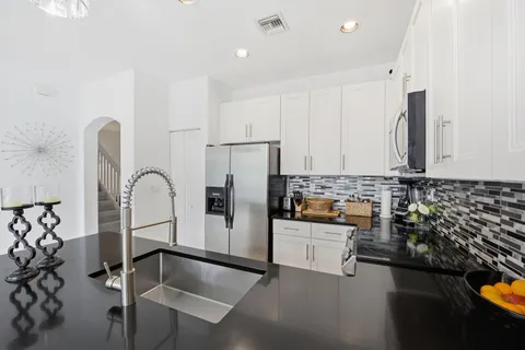 a kitchen with refrigerator and cabinets