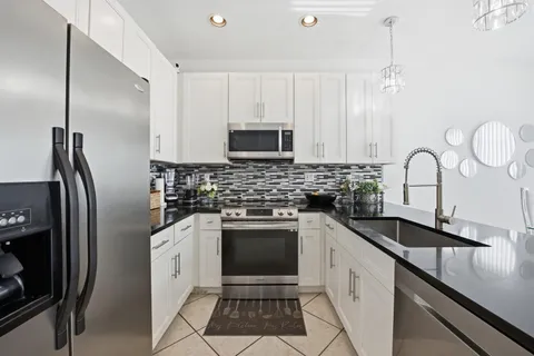a kitchen with a sink stove and refrigerator