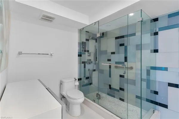 a bathroom with a shower and a toilet