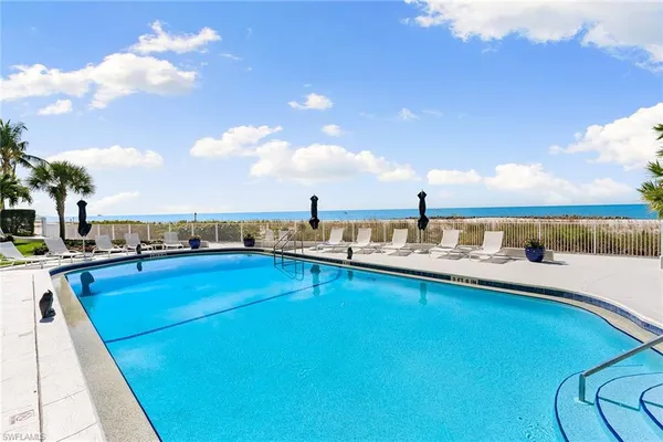 a view of a swimming pool and an outdoor seating