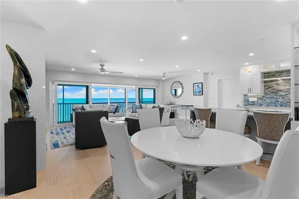 a view of a dining room with furniture and a kitchen