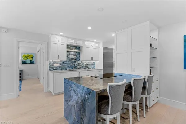 a kitchen with kitchen island cabinets and refrigerator