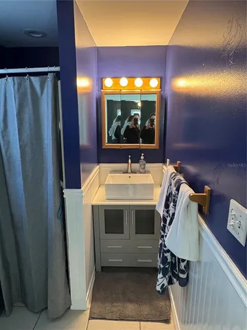 a view of bathroom with a sink and mirror