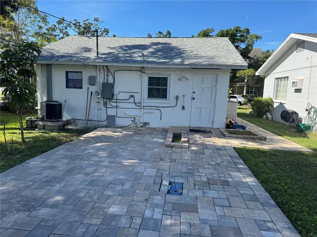 a view of a white house next to a yard
