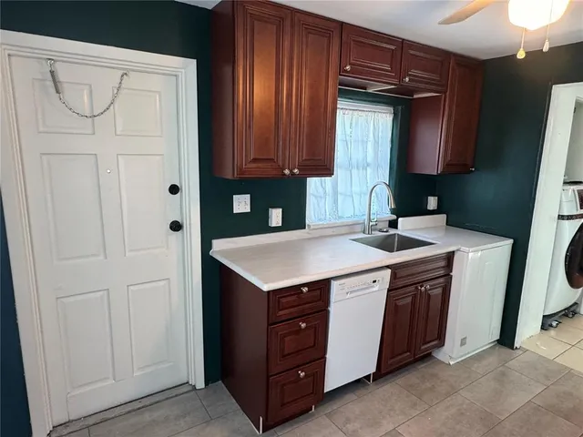 a kitchen with stainless steel appliances granite countertop a sink and a stove