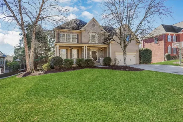 a view of a living room with a white furniture wooden floor and a kitchen view