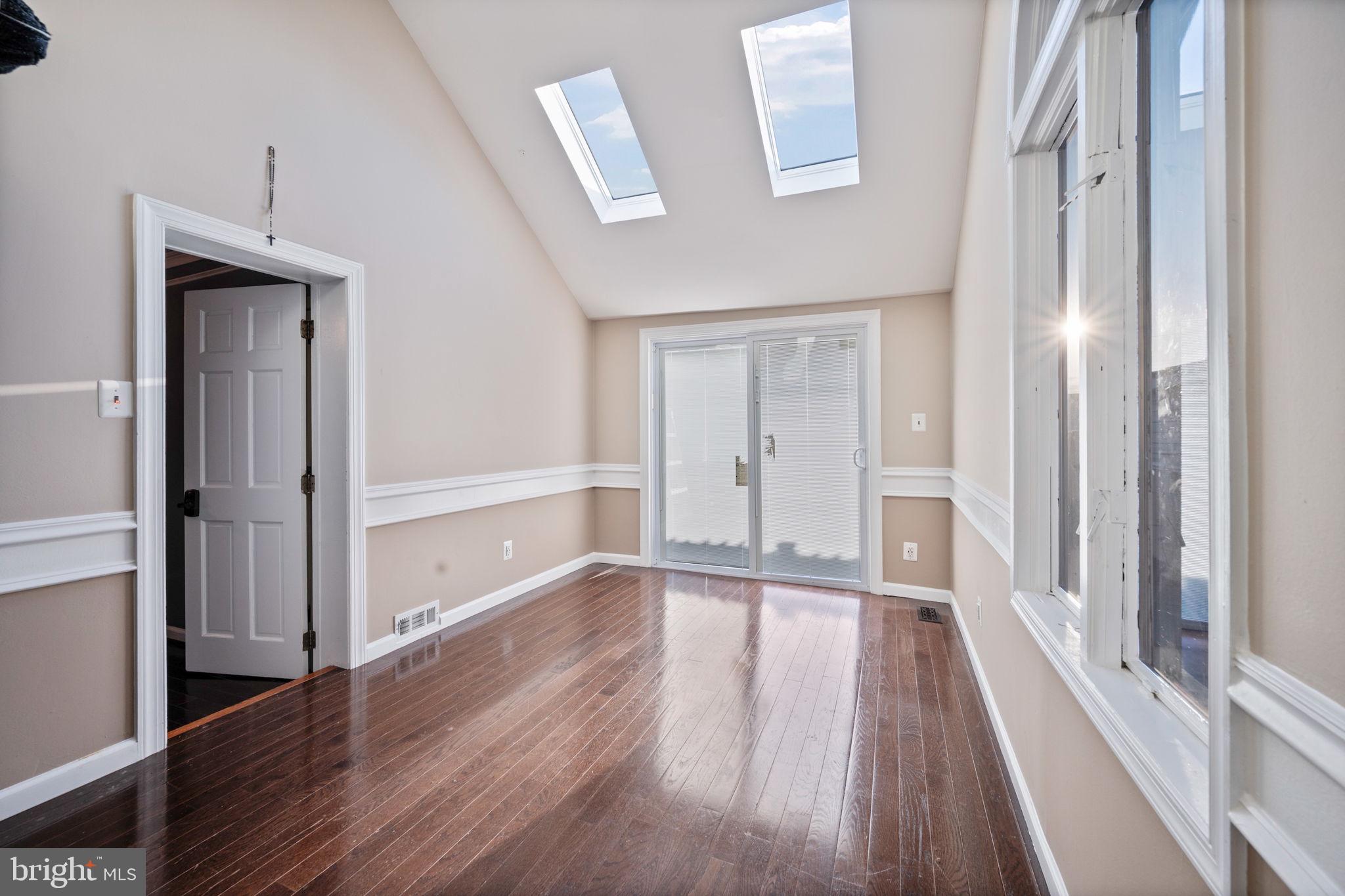 7902 Bridge Avenue Baltimore, MD 21237 - Photo 17 of 28 a view of a hallway with wooden floor