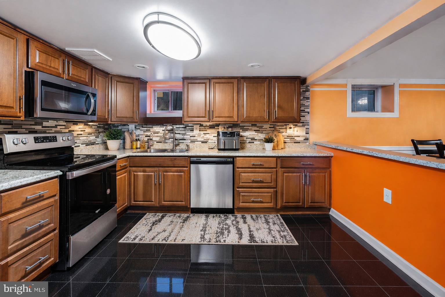 7902 Bridge Avenue Baltimore, MD 21237 - Photo 5 of 28 a kitchen with a sink stove and cabinets