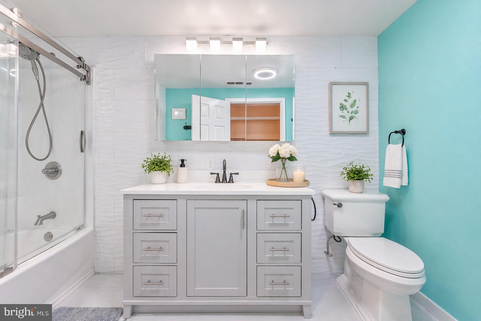 7902 Bridge Avenue Baltimore, MD 21237 - Photo 9 of 28 a bathroom with a sink a toilet and shower