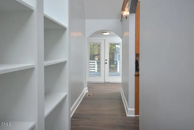 a kitchen with granite countertop a stove top oven microwave and cabinets