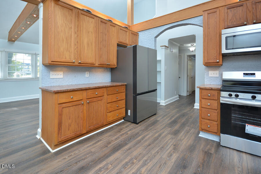 220 Bill Poole Road Rougemont, NC 27572 - Photo 13 of 63 a kitchen with stainless steel appliances granite countertop a refrigerator a stove and a wooden cabinets