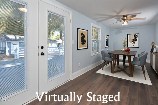 a bedroom with a bed and large windows