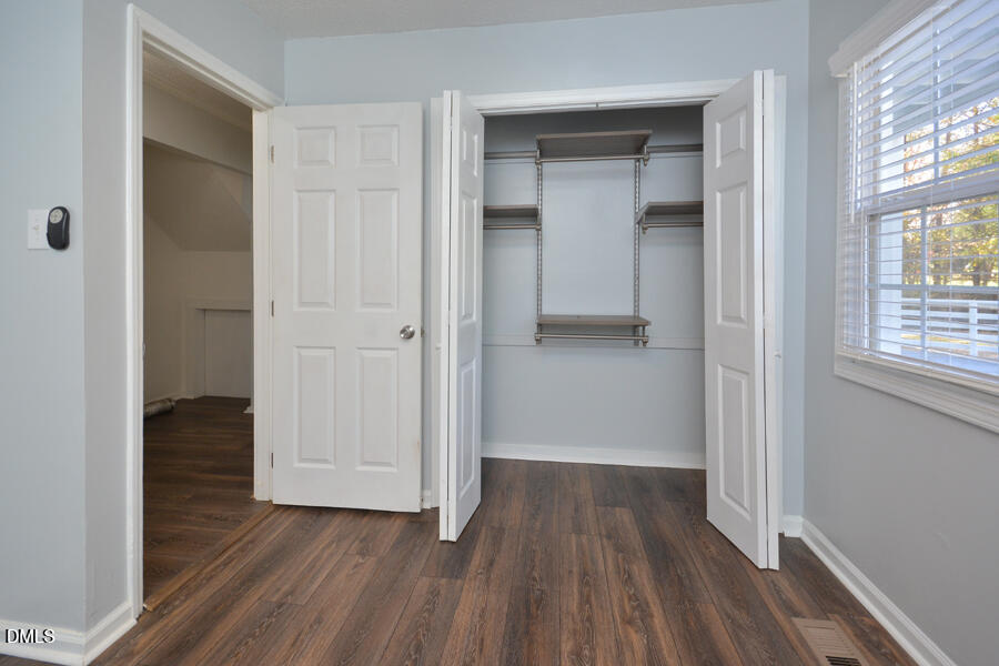 220 Bill Poole Road Rougemont, NC 27572 - Photo 26 of 63 an empty room with wooden floor and windows