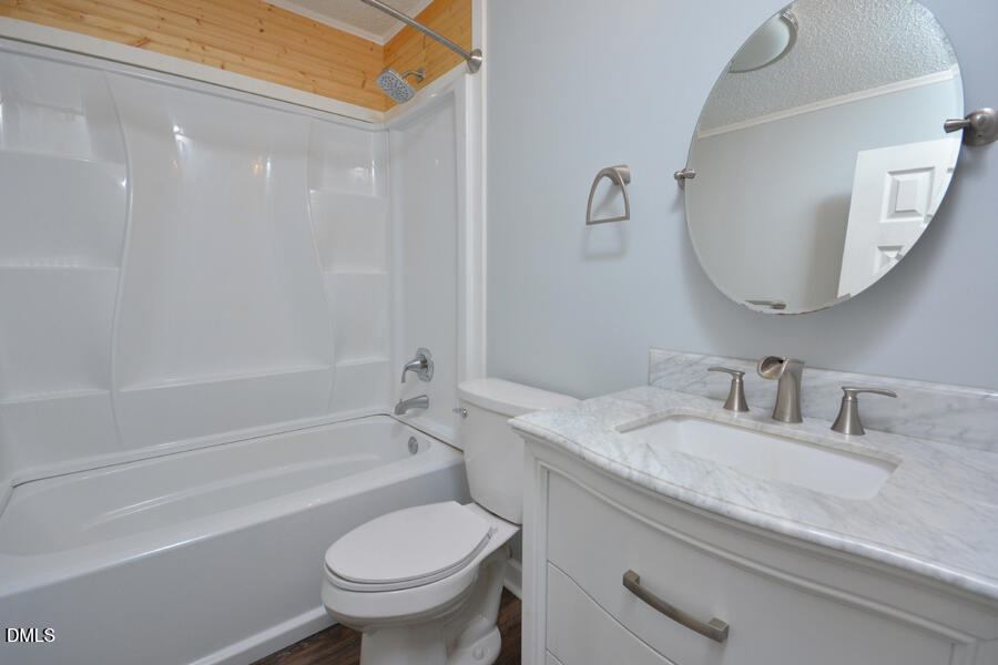 220 Bill Poole Road Rougemont, NC 27572 - Photo 29 of 63 a bathroom with a granite countertop toilet a sink and a bathtub