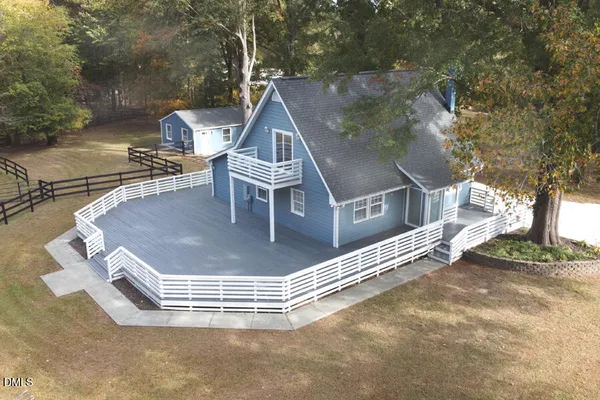 a view of a roof deck with wooden floor and fence