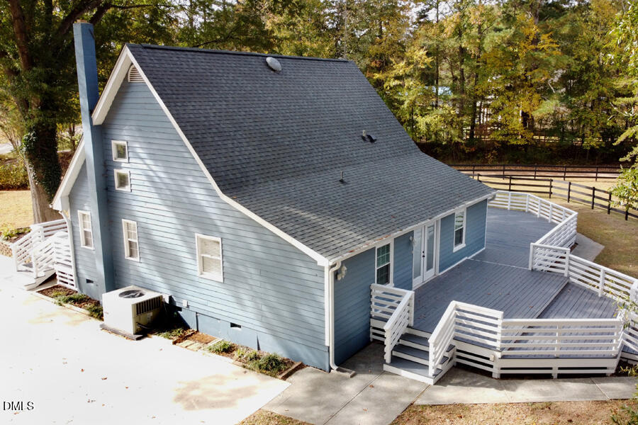 220 Bill Poole Road Rougemont, NC 27572 - Photo 42 of 63 a backyard of a house with wooden fence and trees