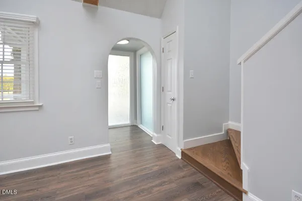 a living room with furniture a flat screen tv and a large window