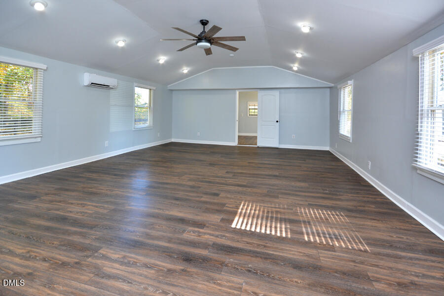220 Bill Poole Road Rougemont, NC 27572 - Photo 53 of 63 an empty room with wooden floor ceiling fan and windows