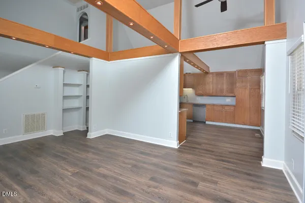 a view of an empty room with wooden floor