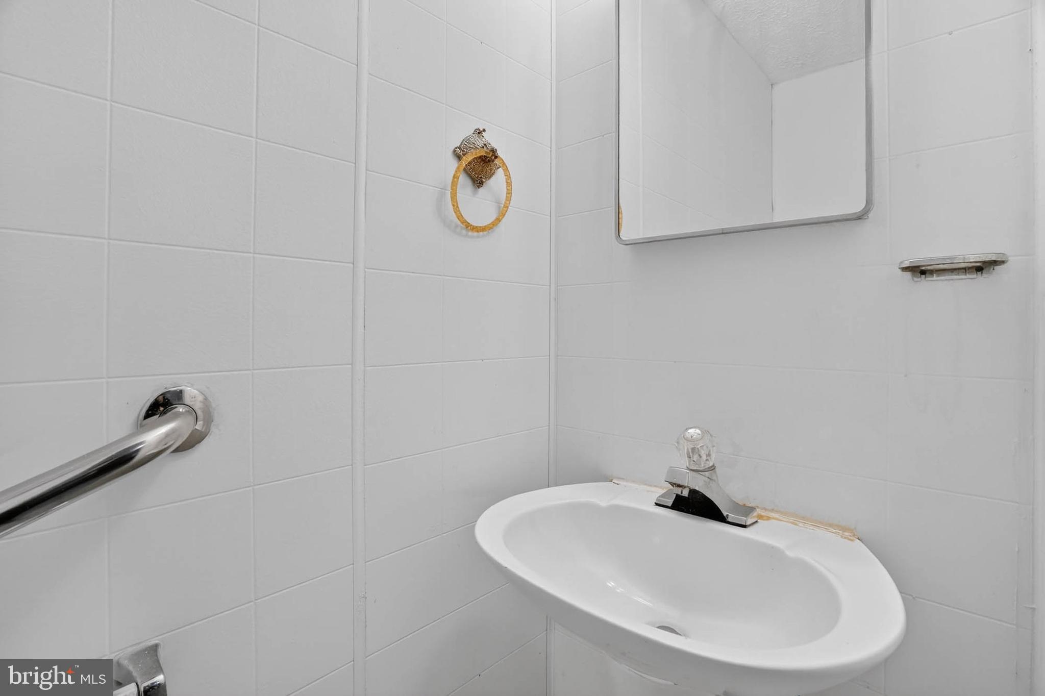 704 Ferguson Road Joppa, MD 21085 - Photo 12 of 30 a bathroom with a sink and a mirror