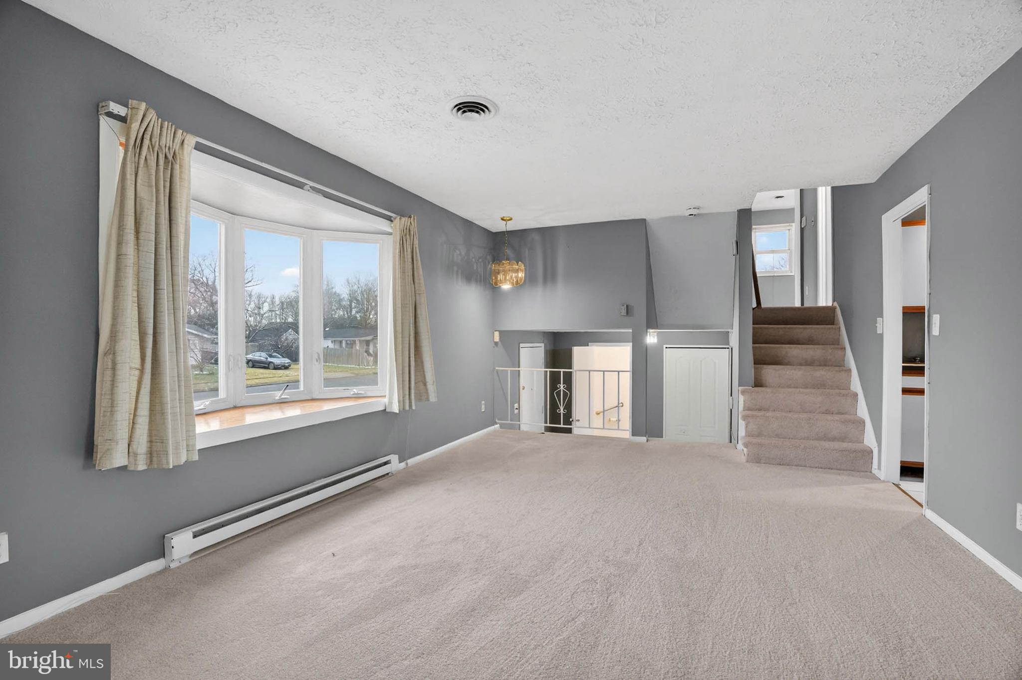 704 Ferguson Road Joppa, MD 21085 - Photo 13 of 30 a view of empty room with stairs and windows