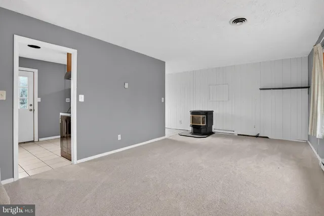 a view of empty room with a fireplace