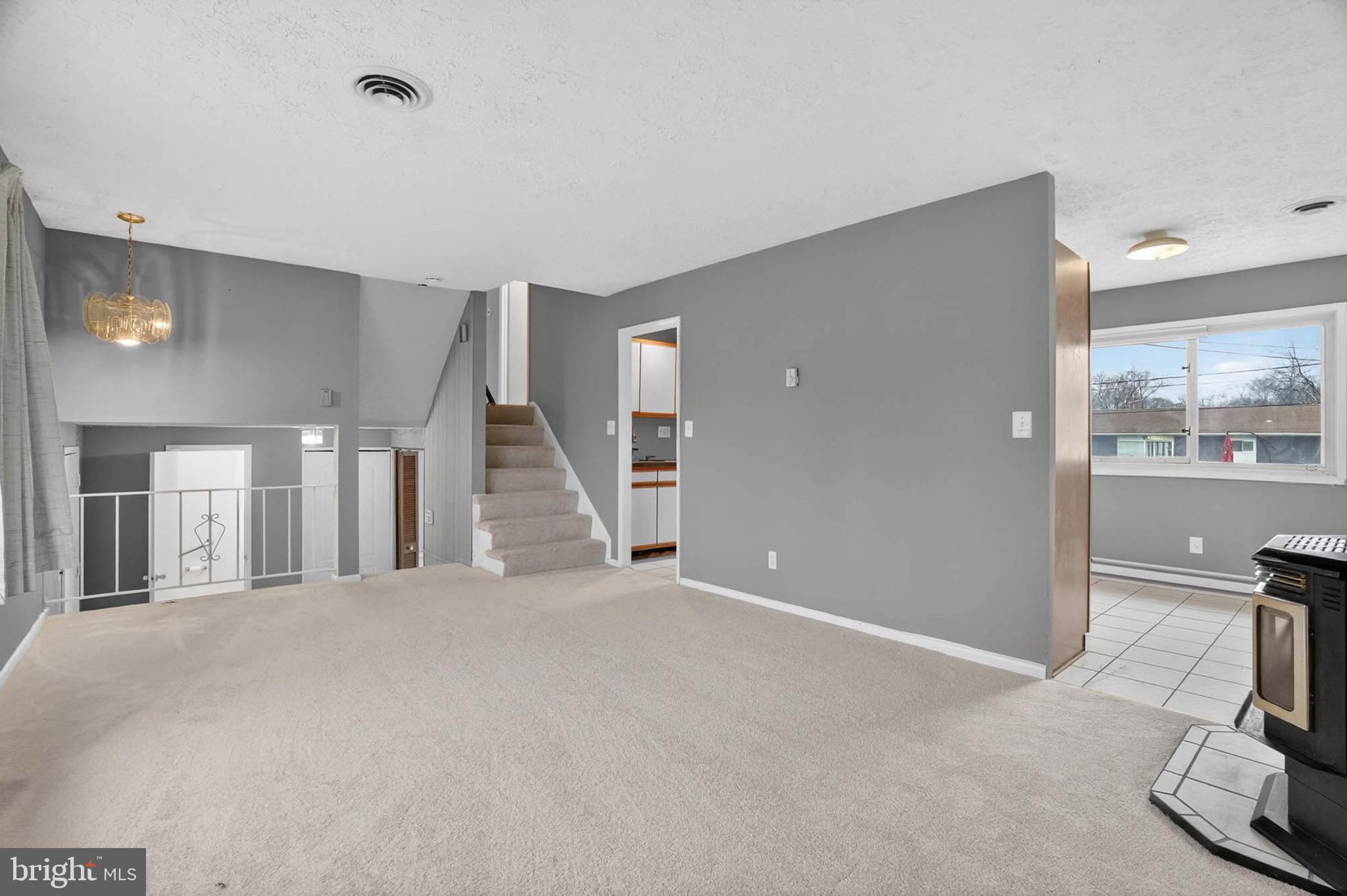 704 Ferguson Road Joppa, MD 21085 - Photo 15 of 30 a view of a livingroom with a flesh screen tv and stairs