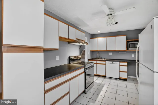 a kitchen with a sink appliances and cabinets