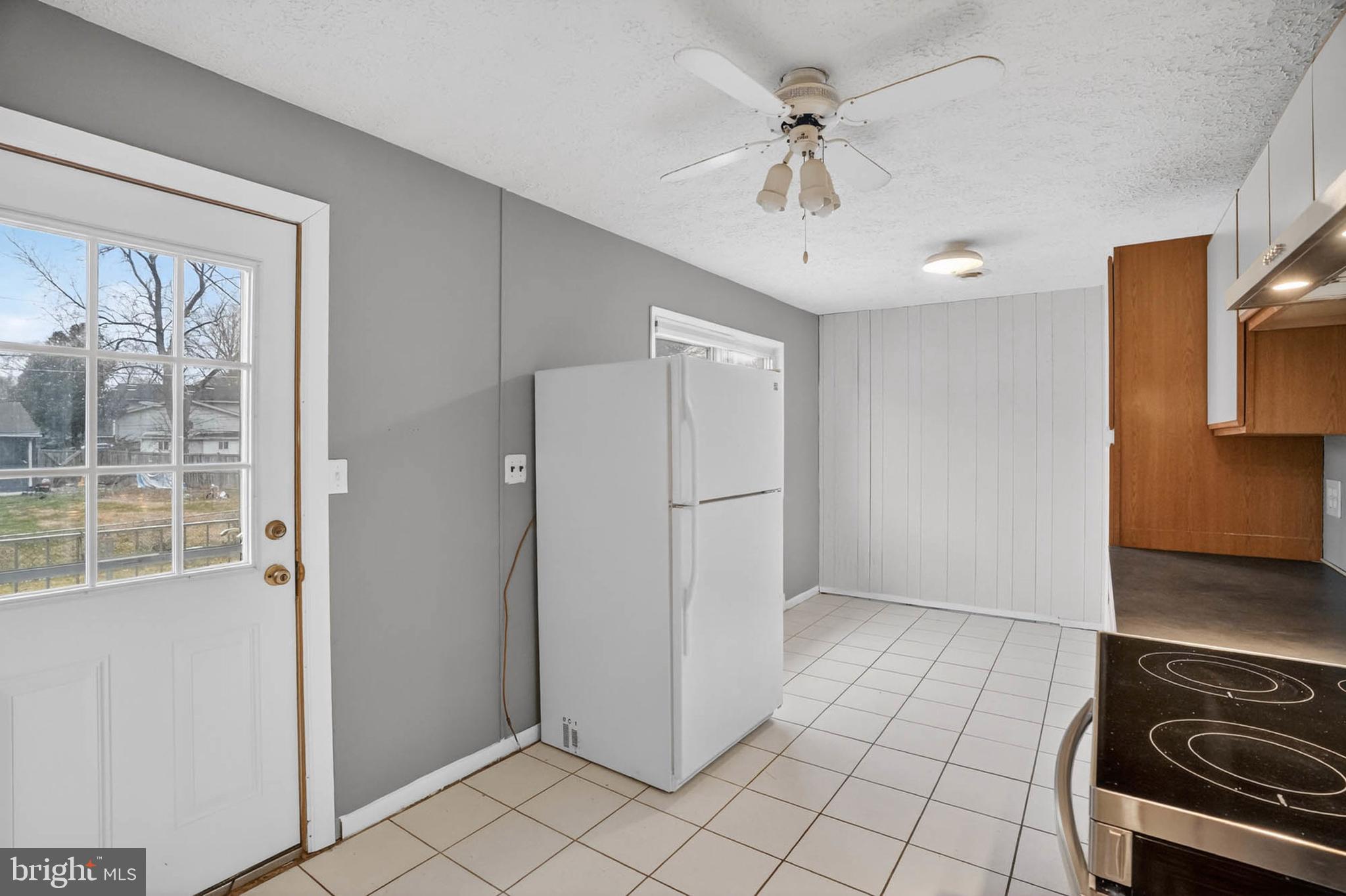 704 Ferguson Road Joppa, MD 21085 - Photo 19 of 30 a view of a kitchen with a stove cabinets and a refrigerator