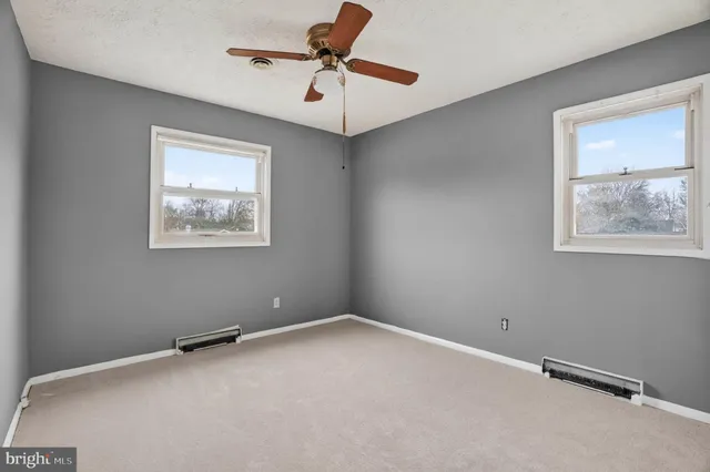 a view of room with a fan and a window