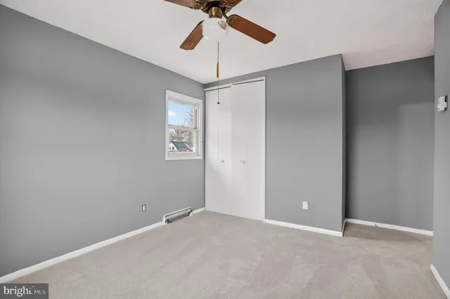 a view of a room with a ceiling fan and a fan