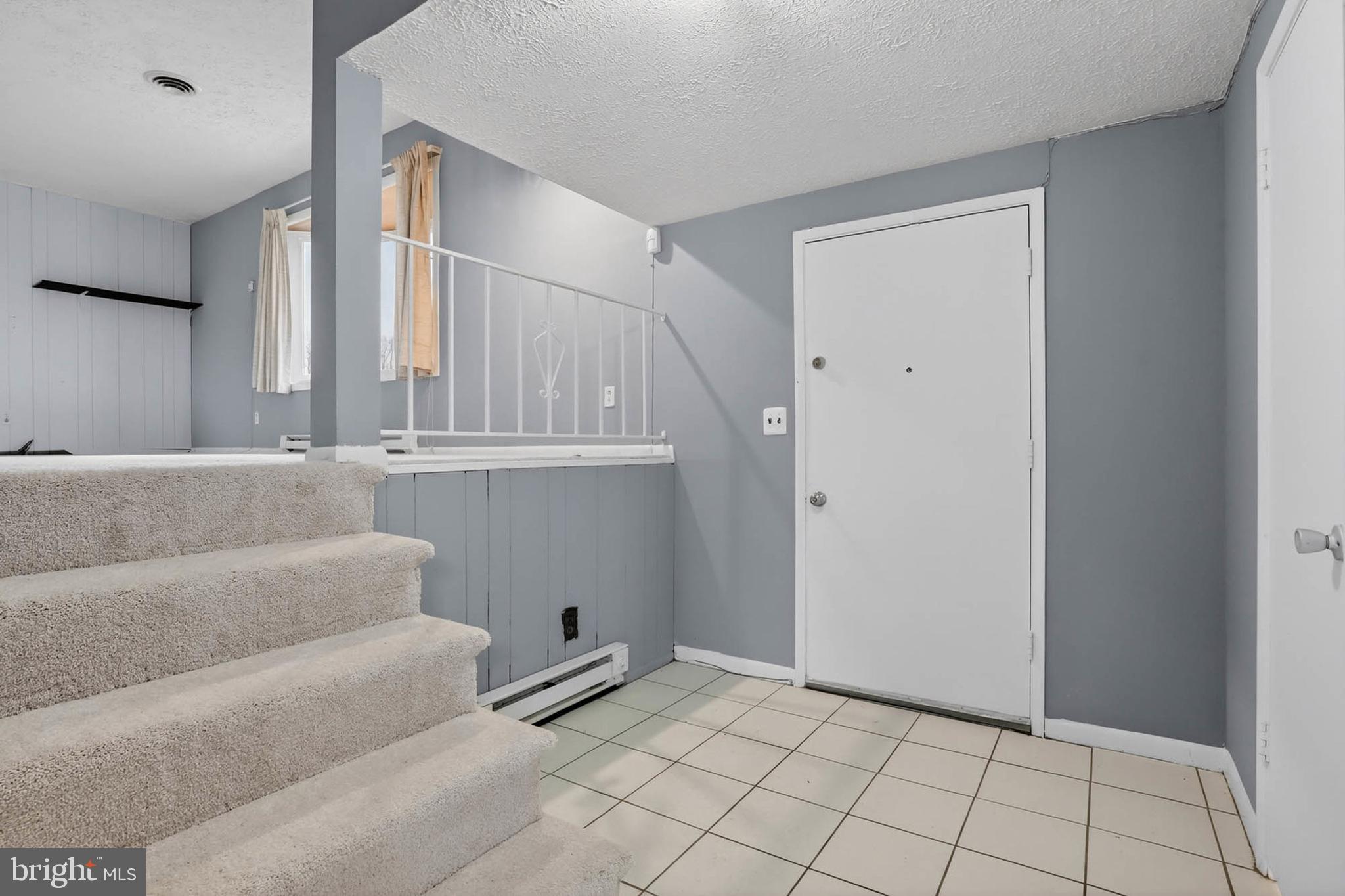 704 Ferguson Road Joppa, MD 21085 - Photo 3 of 30 a view of an empty room with wooden floor and cabinet