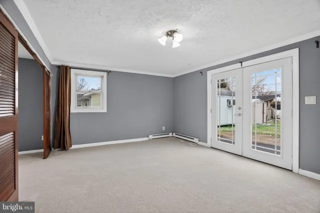 an empty room with windows and closet