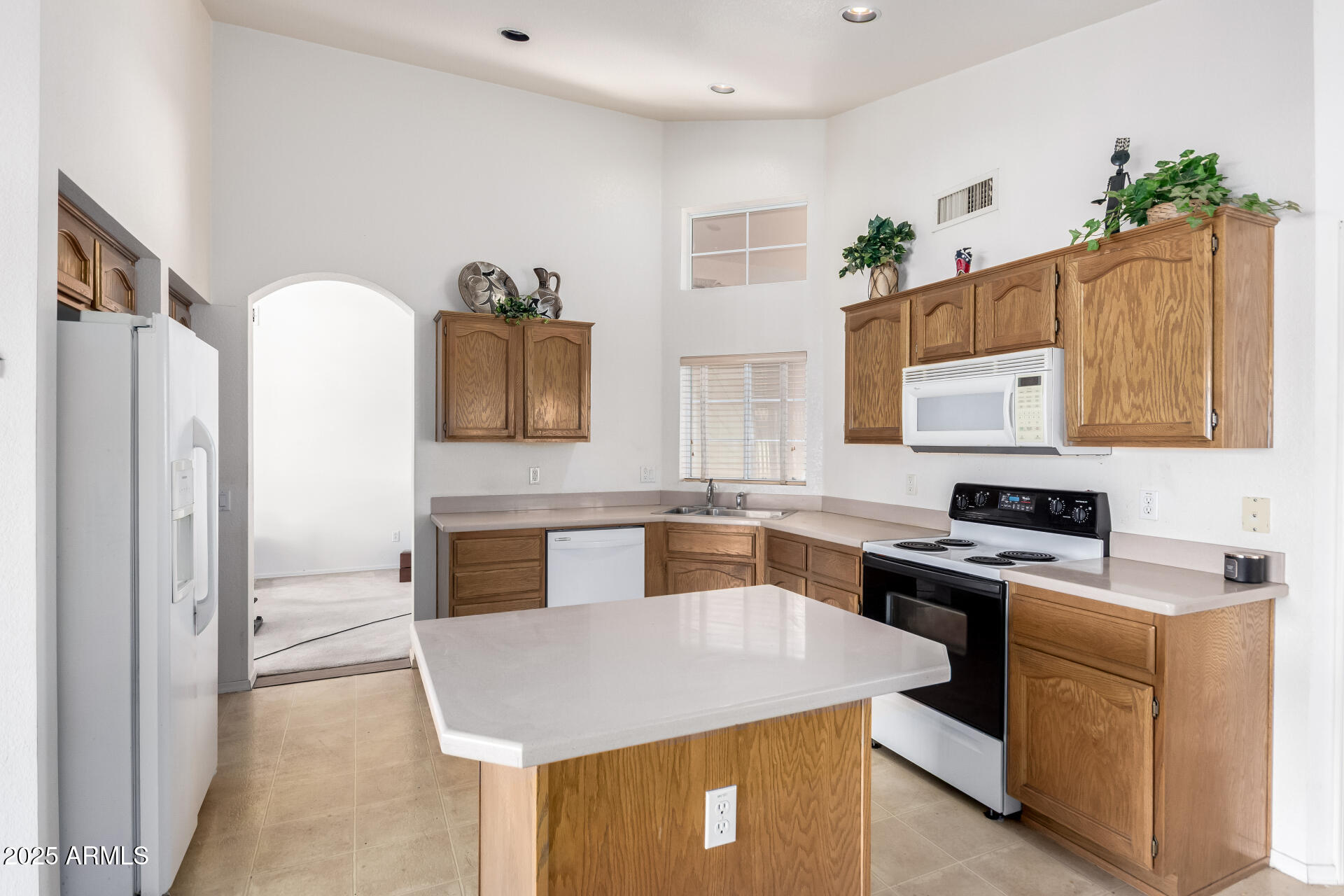 14806 West Verde Lane Goodyear, AZ 85395 - Photo 12 of 30 a kitchen with stainless steel appliances granite countertop a stove a sink and a refrigerator