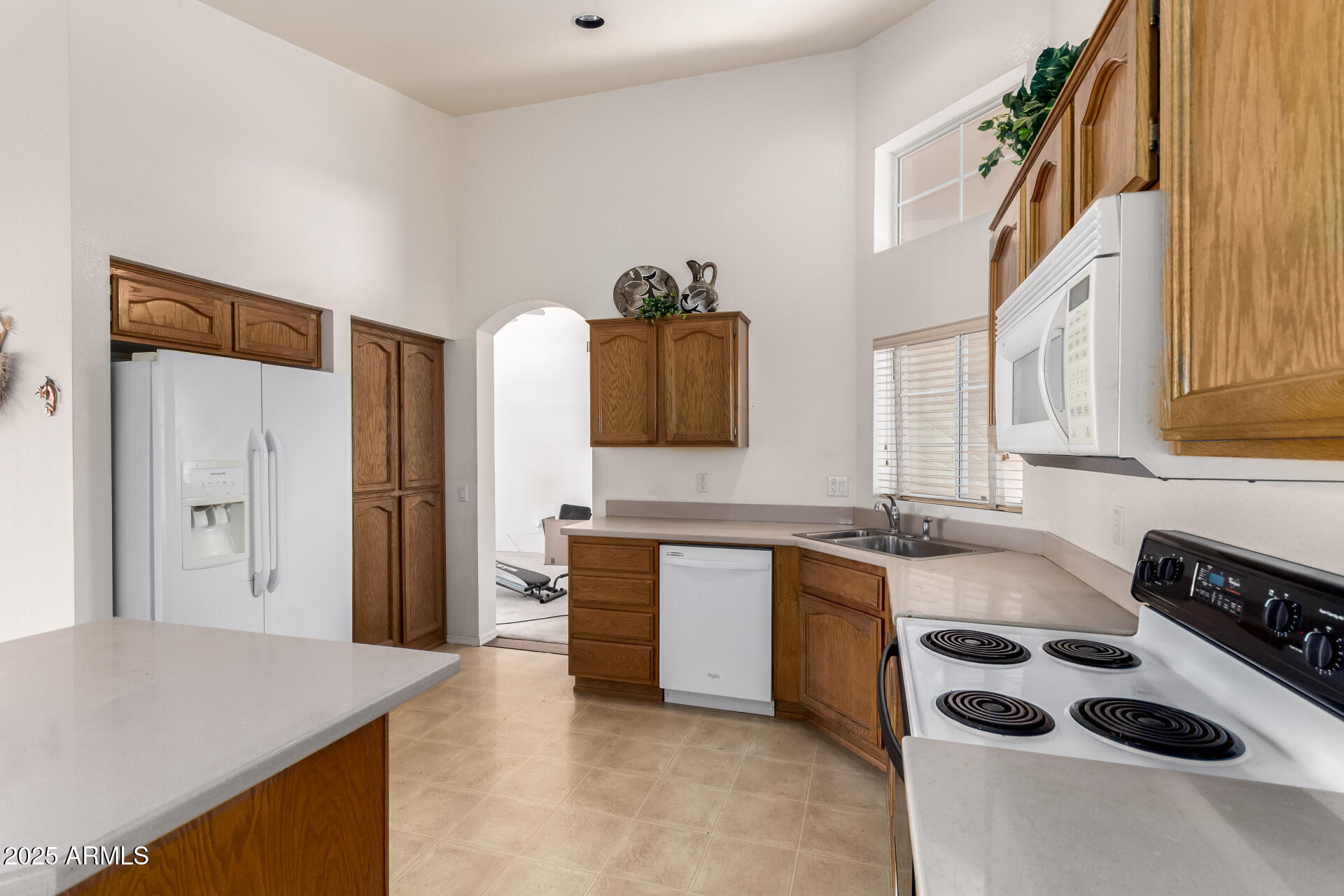 14806 West Verde Lane Goodyear, AZ 85395 - Photo 13 of 30 a kitchen with stainless steel appliances a sink a stove and a refrigerator