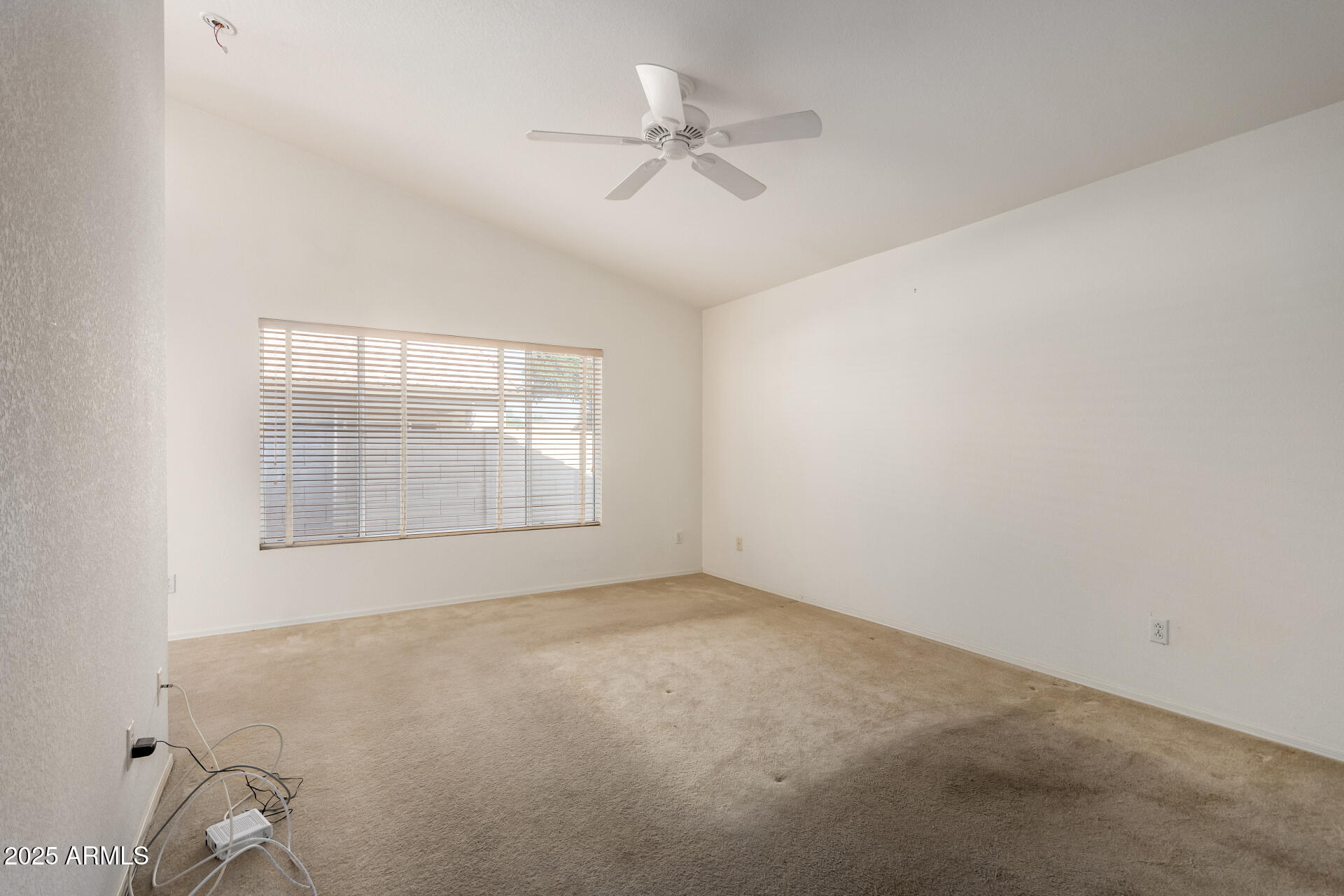 14806 West Verde Lane Goodyear, AZ 85395 - Photo 22 of 30 an empty room with a window and a ceiling fan
