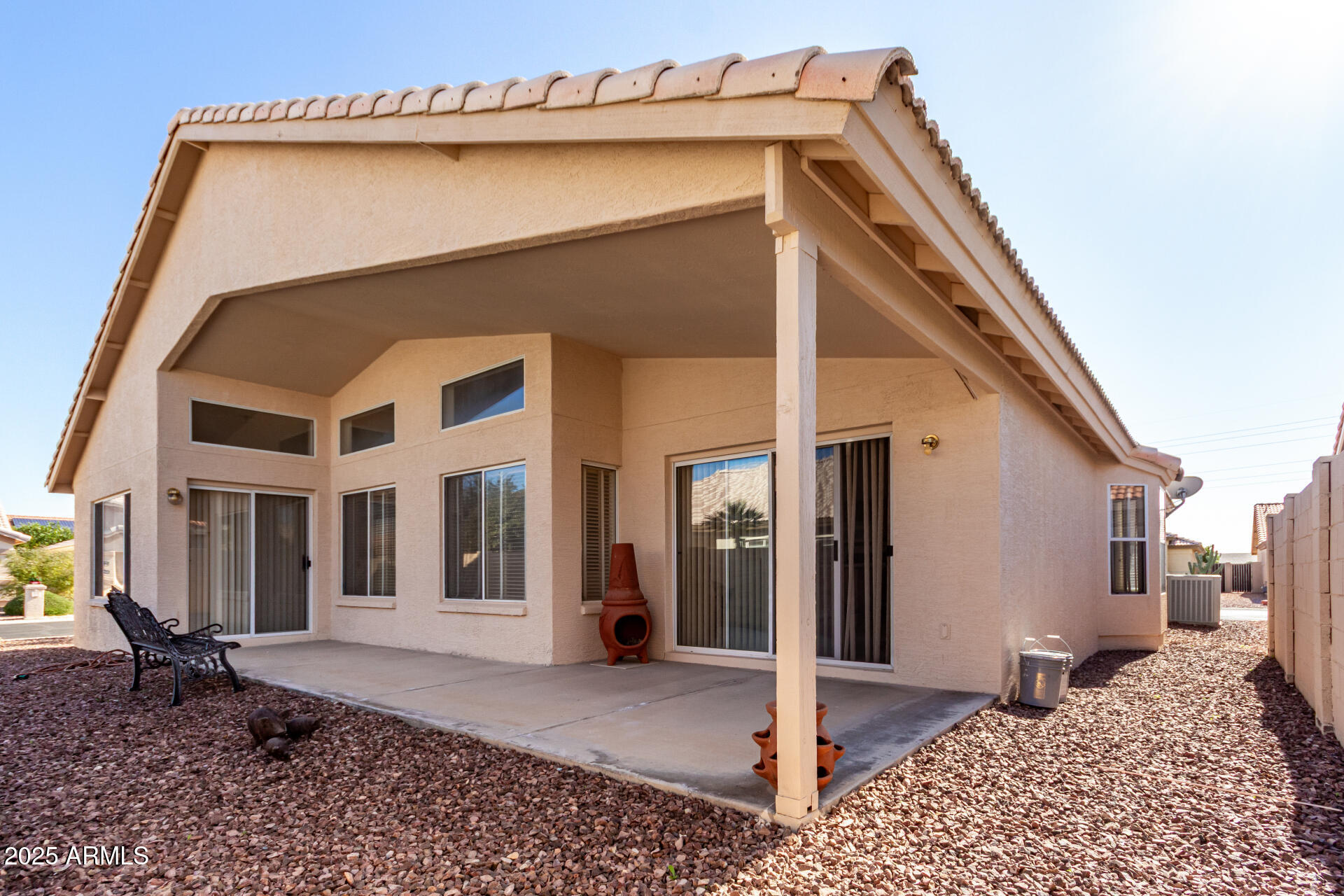 14806 West Verde Lane Goodyear, AZ 85395 - Photo 29 of 30 a backyard of a house with barbeque oven table and chairs