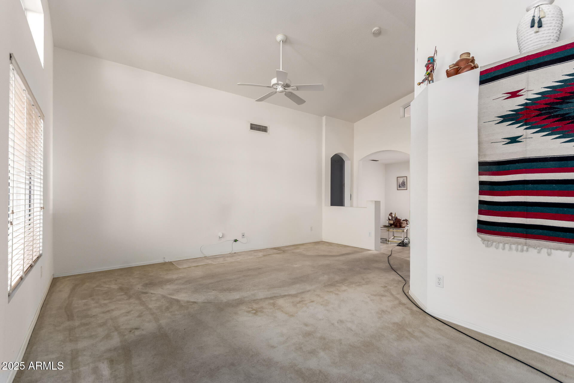 14806 West Verde Lane Goodyear, AZ 85395 - Photo 7 of 30 an empty room with windows and ceiling fan